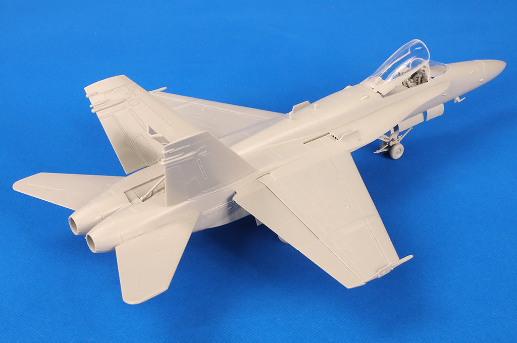 HobbyBoss 1/48 F/A-18C Hornet 85810 unpainted model rear view with detailed engines and landing gear.