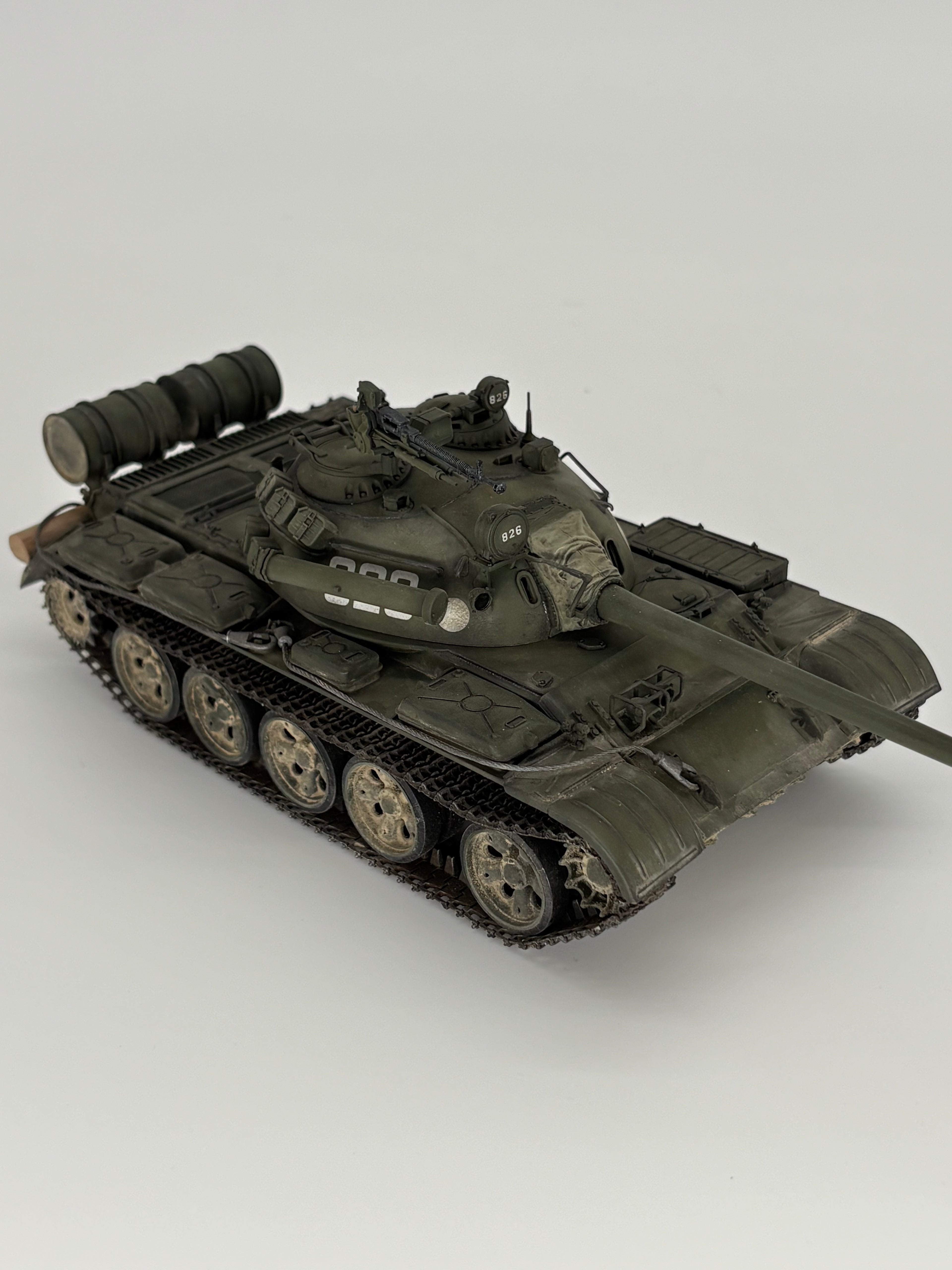 A detailed model of a Tamiya T-55A tank, shown on a neutral light gray background.