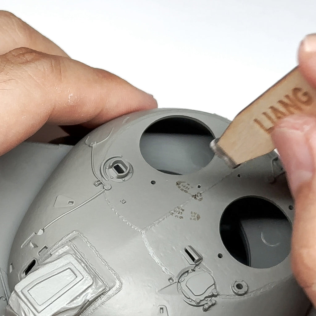 Liang LIANG-0406B 1/35 Modern Footprint Stamp being used to create boot tread impressions on a model surface.