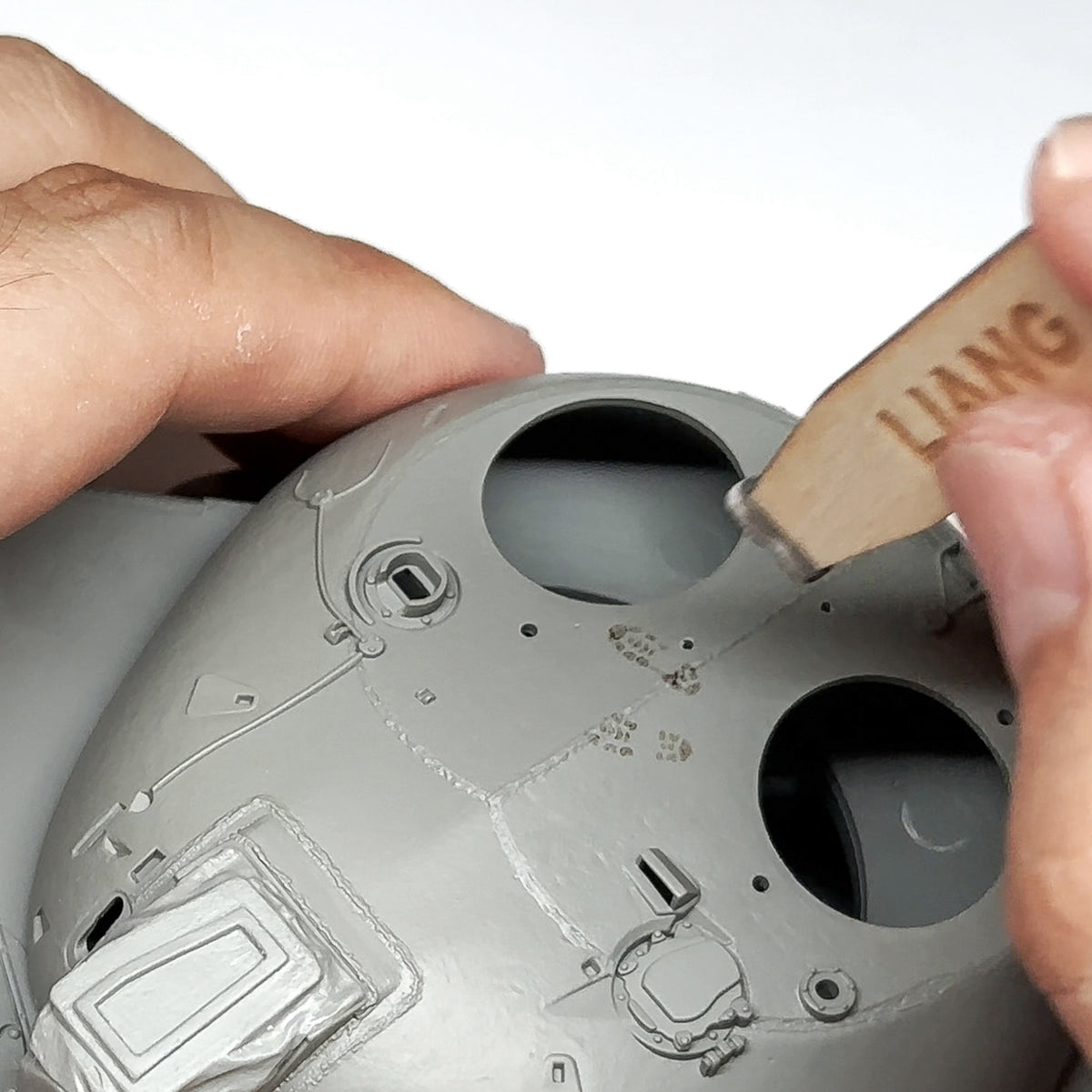 Liang LIANG-0406B 1/35 Modern Footprint Stamp being used to create boot tread impressions on a model surface.