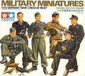 Front cover of a Tamiya model kit box for a German tank crew miniature set, showing illustrated uniformed soldiers in military dress and camouflage on a white background with the Tamiya logo.