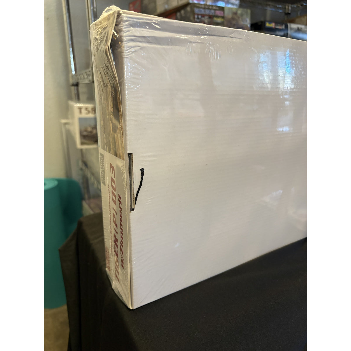 Amusing Hobby 35A059 Tiger (P) 003 1/35 kit box, side view of the crushed lid corner pulled away from the tray, shrink wrap intact