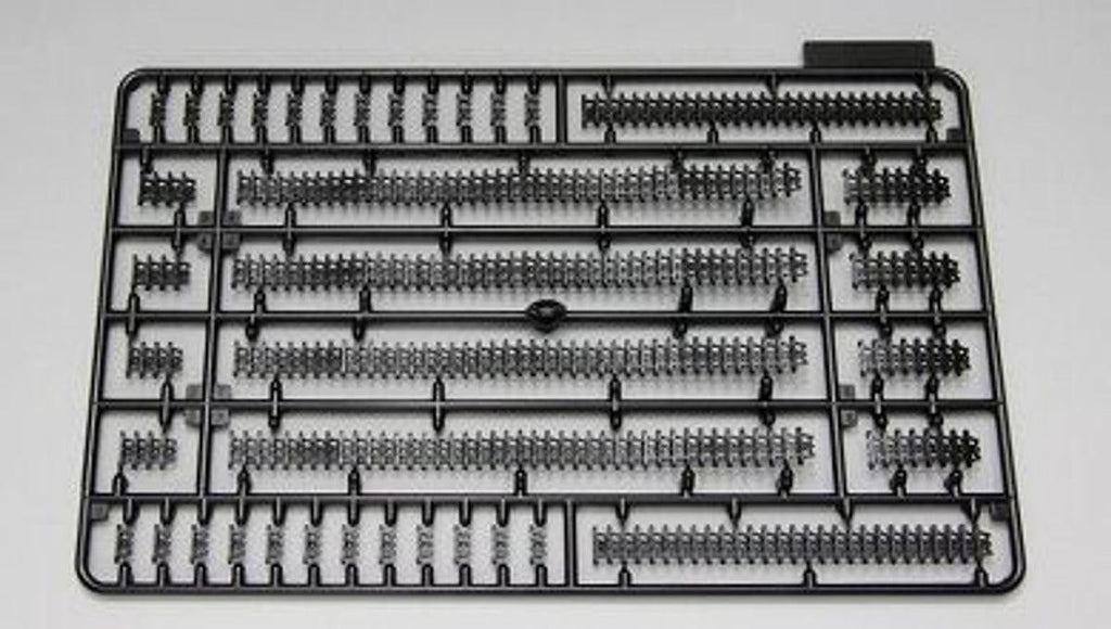 Model kit parts on a black plastic tray against a white background
