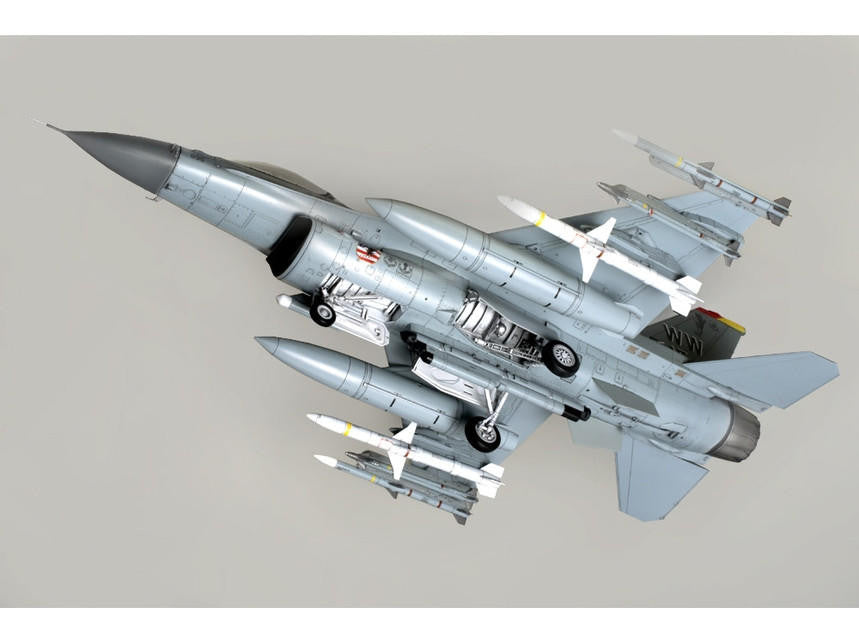 Model of a fighter jet with missiles on a gray background