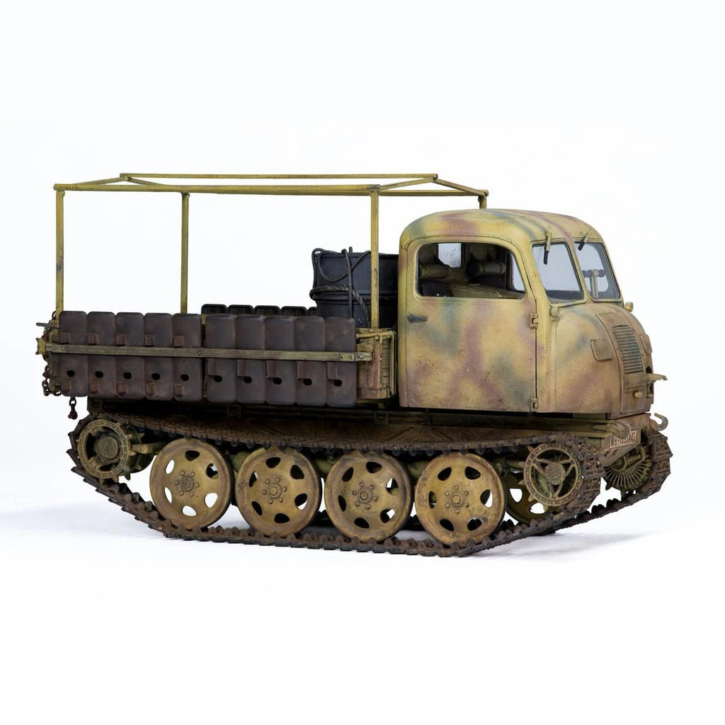 Built Tamiya 1/35 RSO/01 German tractor model in three-tone camouflage with open cargo bed frame, front three-quarter view