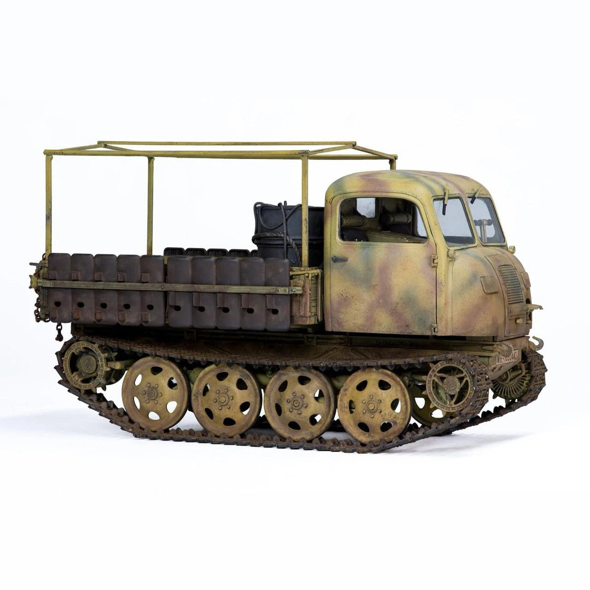 Built Tamiya 1/35 RSO/01 German tractor model in three-tone camouflage with open cargo bed frame, front three-quarter view