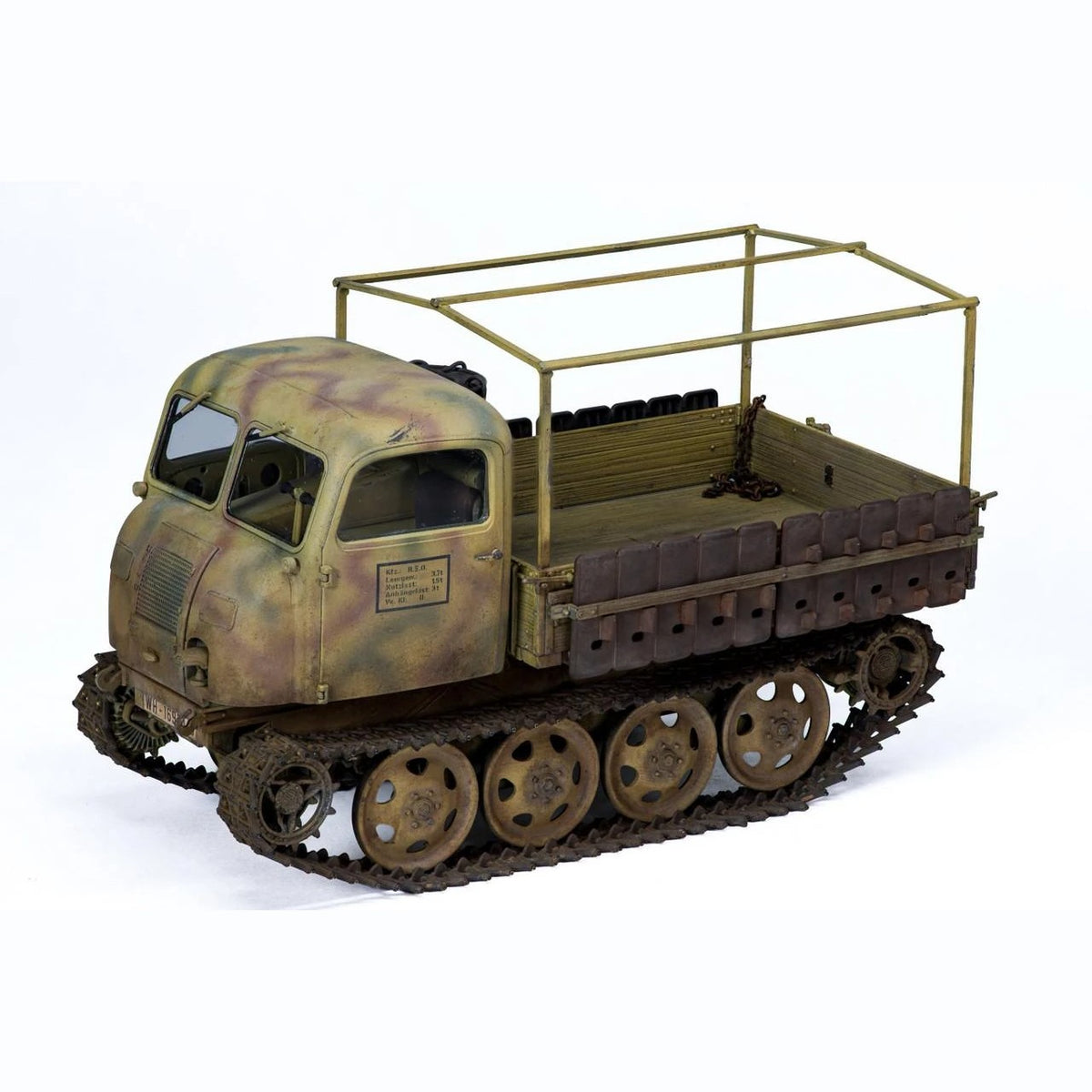 Built Tamiya 1/35 RSO/01 tractor model showing rounded cab, wooden cargo bed and spare track links on the side