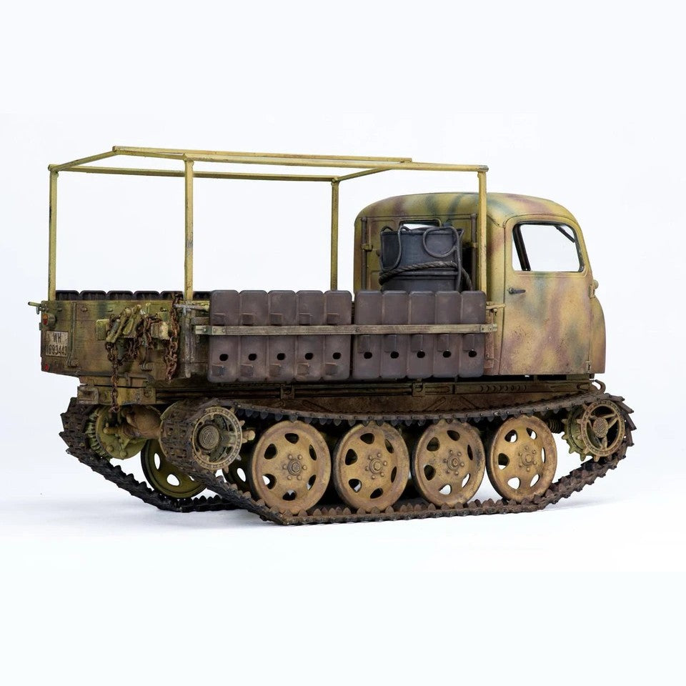 Side view of a built Tamiya 1/35 RSO/01 tracked tractor showing road wheels, tracks and cargo bed frame