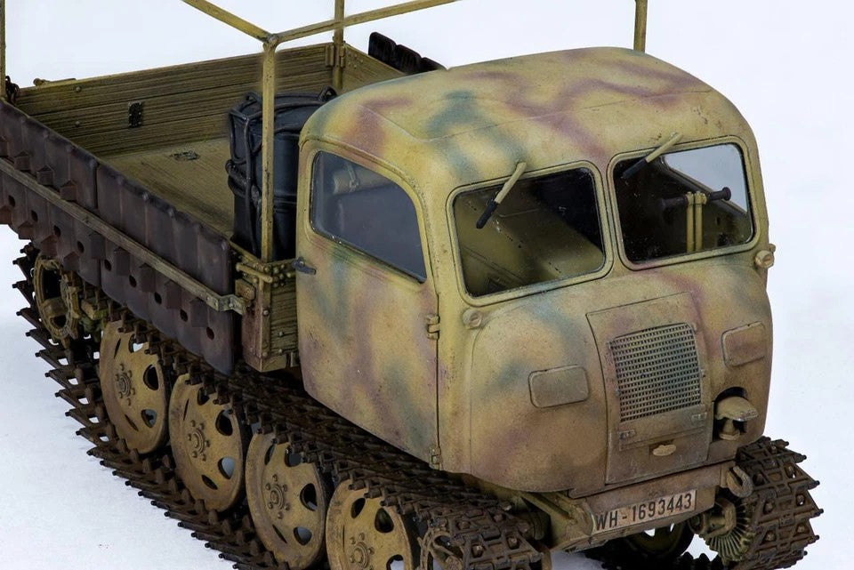 Close-up of the Tamiya 1/35 RSO/01 rounded cabin with camouflage paint, windshield wipers and engine grille